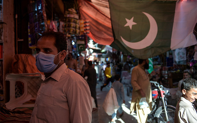A man wearing a face mask as a preventive measure against the COVID-19 shops at the Raja Bazar in Rawalpindi, Pakistan, on July 22, 2020. (AFP/File)