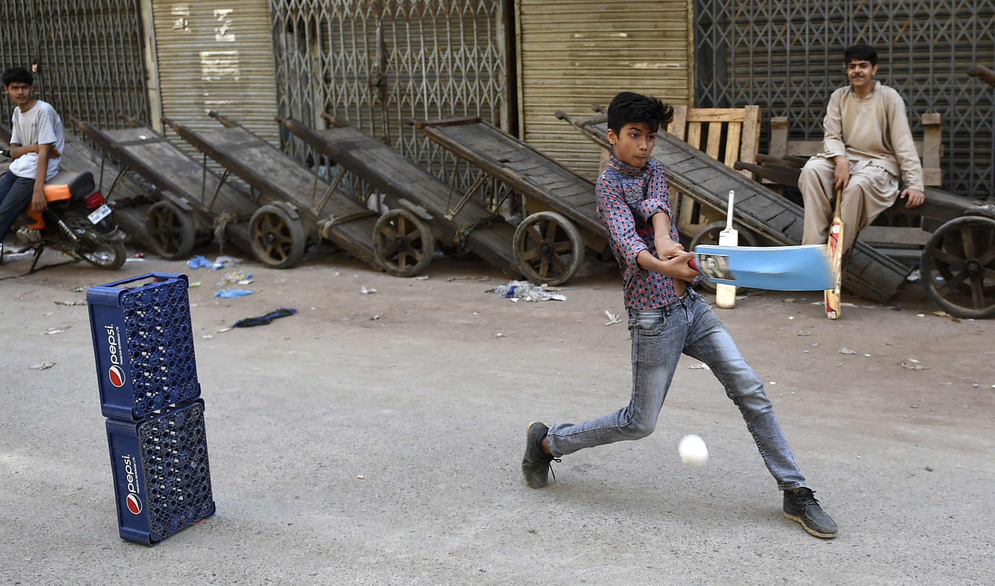 Children play cricket in a shuttered market after a lockdown was imposed to control the spread of the Covid-19 coronavirus in Karachi on April 11, 2021. (AFP/File)