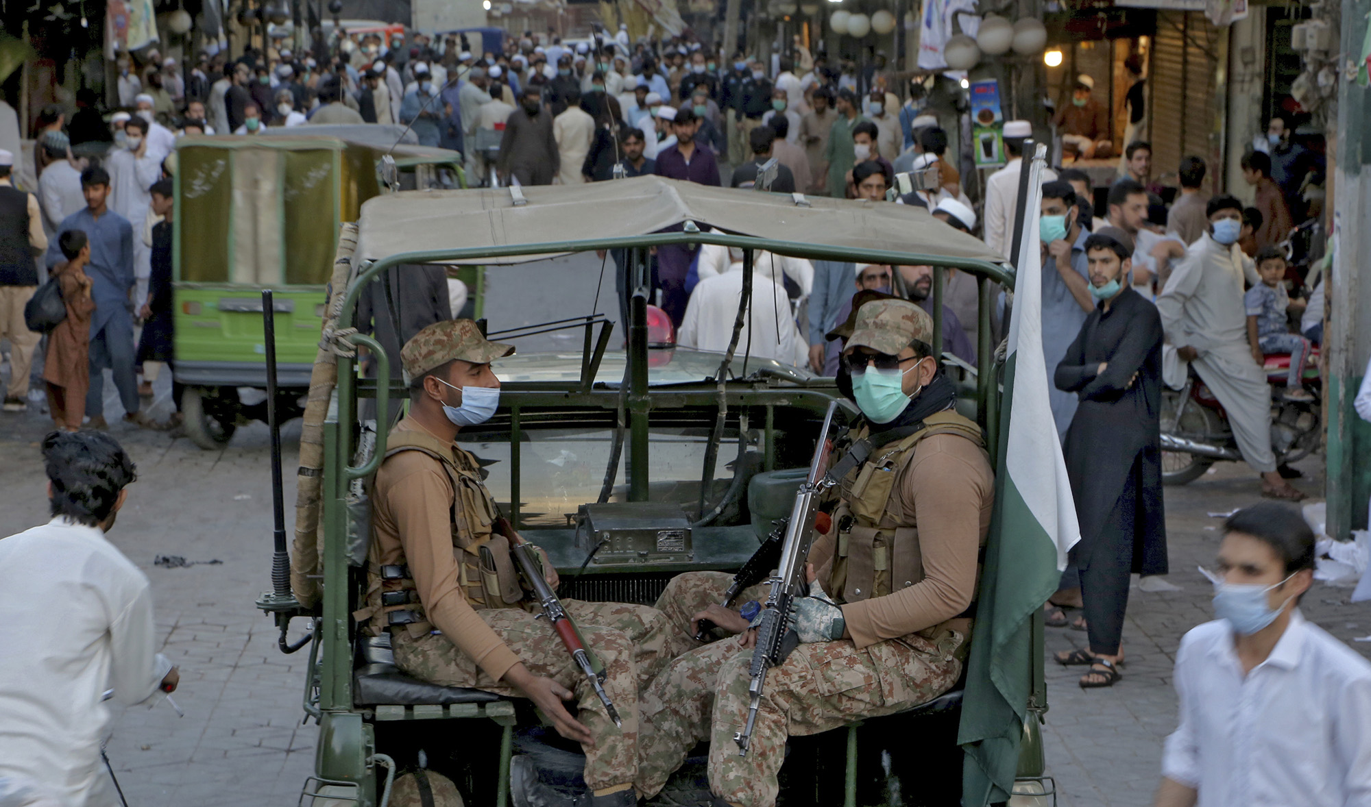 Pakistan army troops arrive to ensure new timing of market closing announced by government to control the spread of the coronavirus, in Peshawar, Pakistan, on April 24, 2021. (AP)