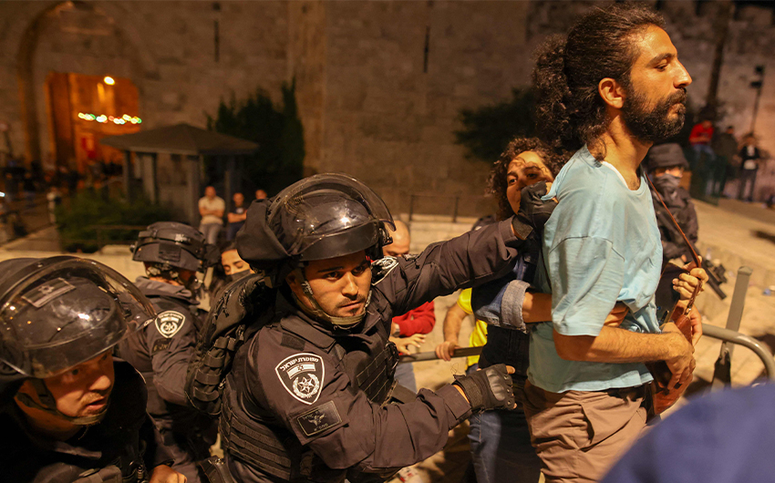 Israeli policemen arrest a Palestinian protester in Jerusalem's Old City on April 25, 2021. (AFP)