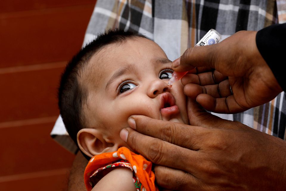 A girl receives polio vaccine drops, during an anti-polio campaign, in a low-income neighborhood as the spread of the coronavirus disease (COVID-19) continues, in Karachi, Pakistan July 20, 2020. (REUTERS)