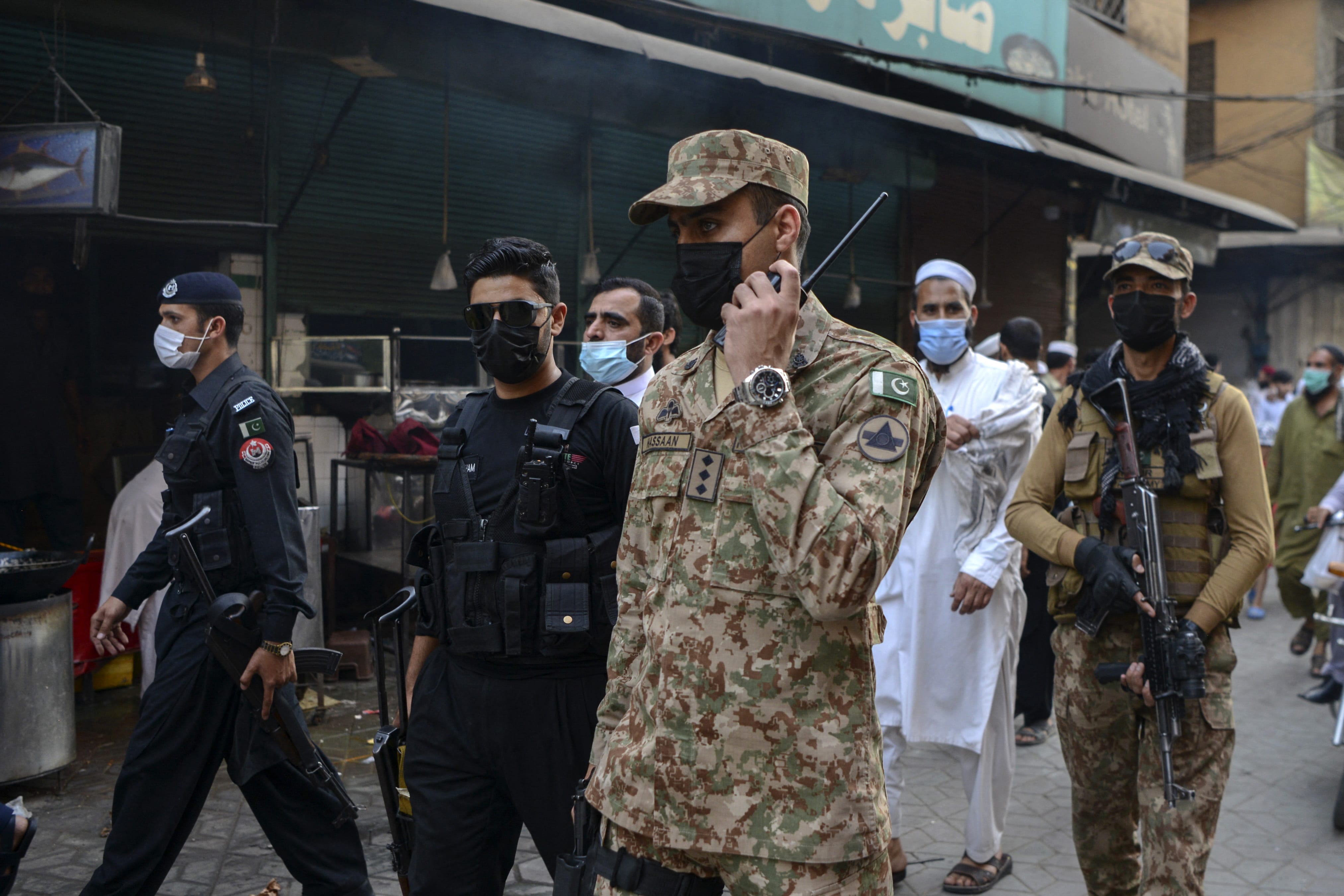 Army soldiers patrol a market to implement new restrictions imposed as a preventive measure against the spread of the Covid-19 coronavirus in Peshawar on April 26, 2021. (AFP)