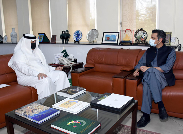 Saudi Arabia's ambassador to Pakistan, Nawaf bin Saeed Al-Maliki (left) talks to Pakistani energy minister Muhammad Hammad Azhar (right) in Islamabad on April 27, 2021. (Photo courtesy: Pakistan's Ministry of Energy)