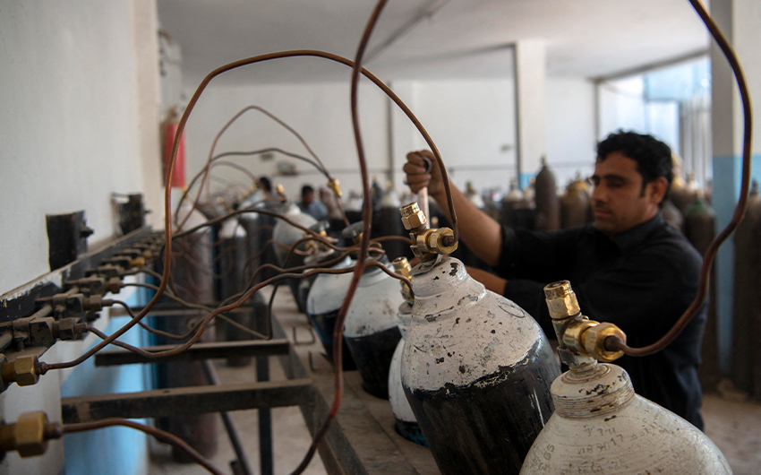 A worker fills oxygen cylinders for hospital use on Covid-19 coronavirus patients, at a factory in Peshawar, Pakistan, on April 12, 2021. (AFP)
