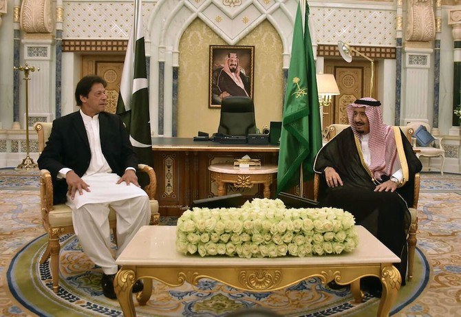 In this handout photograph released by Pakistan’s Press Information Department (PID) on October 23, 2018, Saudi King Salman meets with Pakistan’s Prime Minister Imran Khan during a meeting in Riyadh. Saudi Arabia. (AFP)