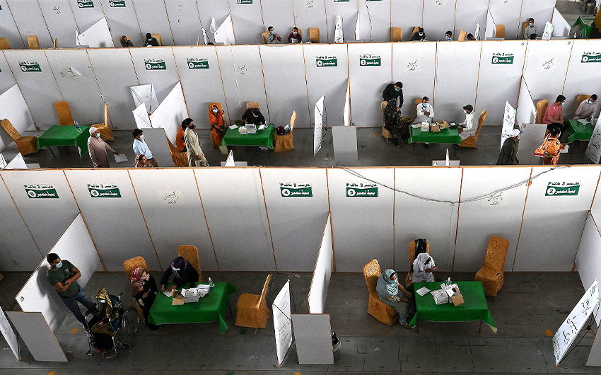 People gather to get themselves inoculated with the Chinese-made Sinopharm Covid-19 coronavirus vaccine at a vaccination camp organized at the Expo center in Lahore, Pakistan, on April 28, 2021. (AFP/File)