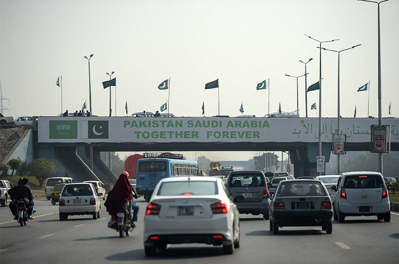 Pakistani commuters drive their vehicles under a banner welcoming Saudi Arabian Crown Prince Mohammed bin Salman displayed on a bridge, ahead of his arrival, in Islamabad on February 15, 2019. (AFP/File)