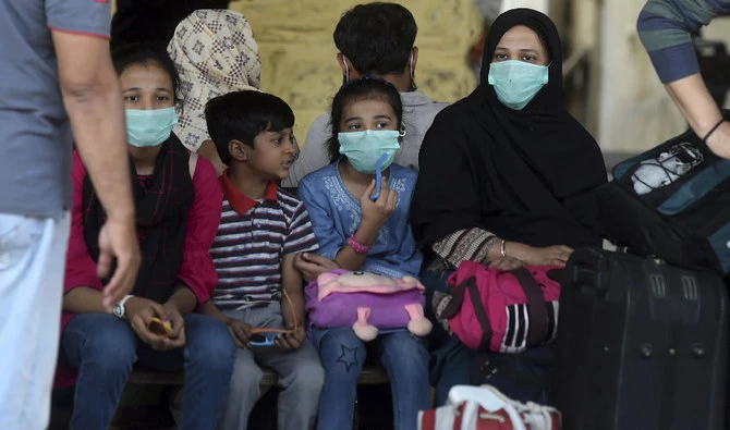 Passengers wearing facemasks amid concerns over the spread of the COVID-19 novel coronavirus, wait at Karachi Cantonment railway station in Karachi on March 16, 2020. (AFP/ File)