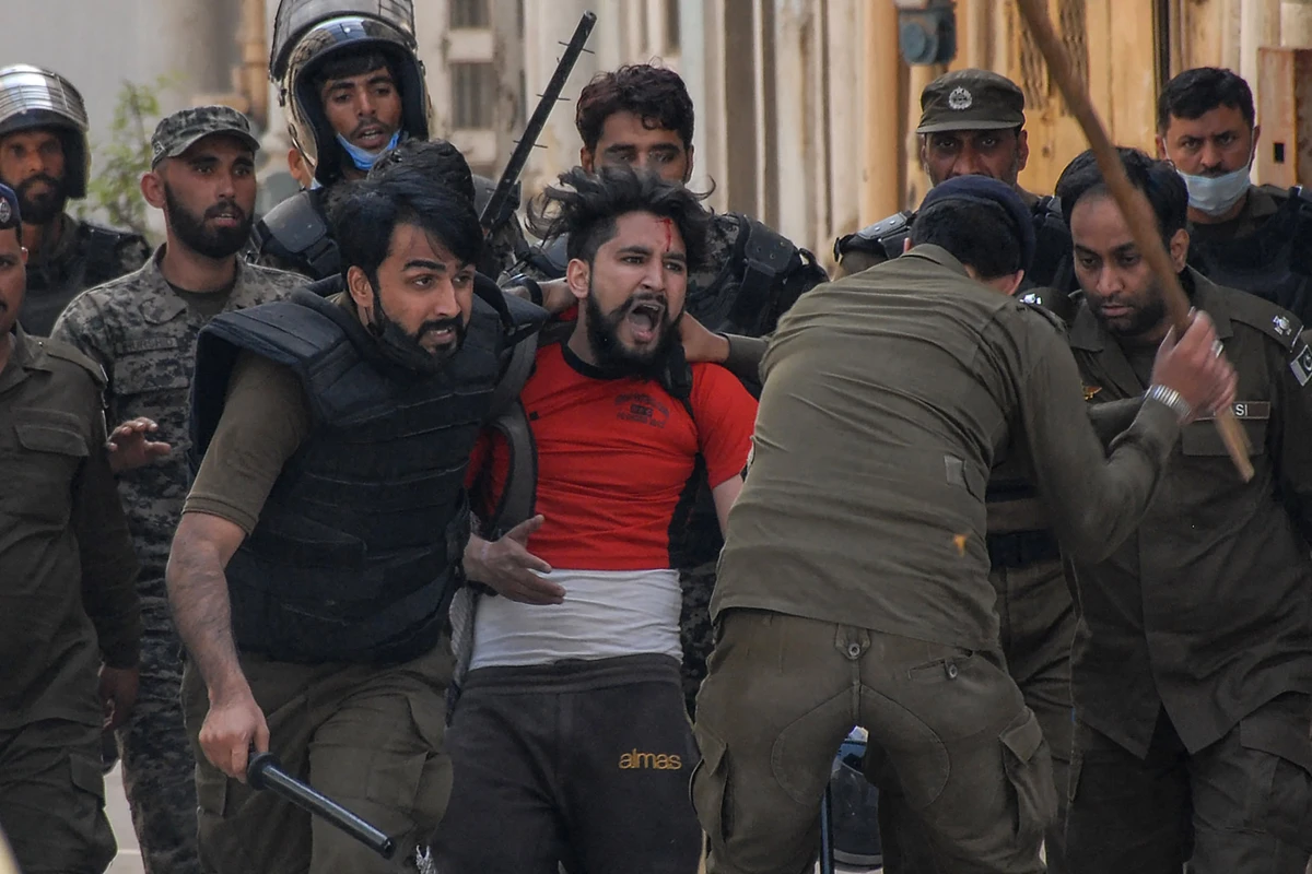 Policemen detain a supporter of Tehreek-e-Labbaik Pakistan (TLP) party during a protest against the arrest of their leader as he was demanding the expulsion of the French ambassador over depictions of Prophet Muhammad, in Rawalpindi on April 14, 2021. (AFP)