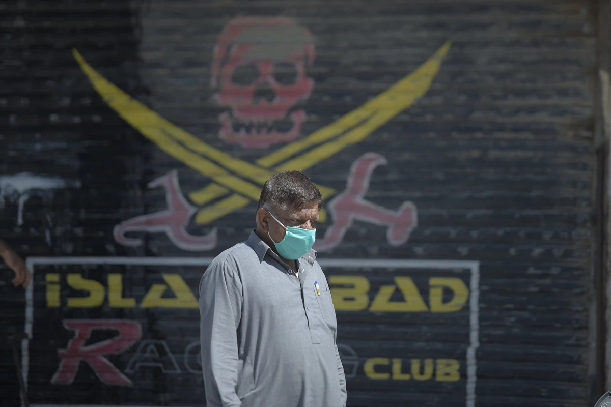 A Pakistani man walks past a closed shop of a market area in Karachi on March 22, 2020. (AFP/ File )