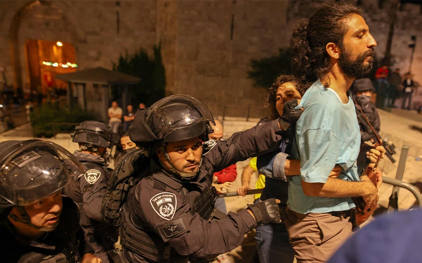 Israeli policemen arrest a Palestinian protester in Jerusalem's Old City on April 25, 2021. (AFP)