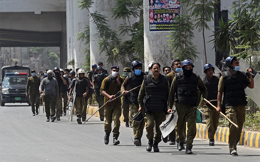 Policemen arrive at the site of a protest by the supporters of Tehreek-e-Labbaik Pakistan (TLP) party along a blocked street during a demonstration in Lahore, Pakistan, on April 18, 2021. (AFP)