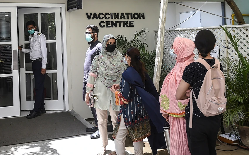 People wait for their turn to receive a dose of the Russia's Sputnik V vaccine against the Covid-19 at a vaccination center in Karachi, Pakistan, on April 5, 2021. (AFP/File)