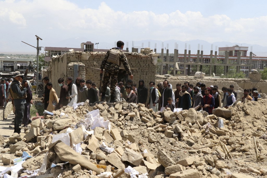 Security personnel and residents gather a day after at the site of a car bomb attack in which at least 25 people were killed and 110 wounded, in the Pul-e-Alam area in Logar province on May 1, 2021. (AFP)