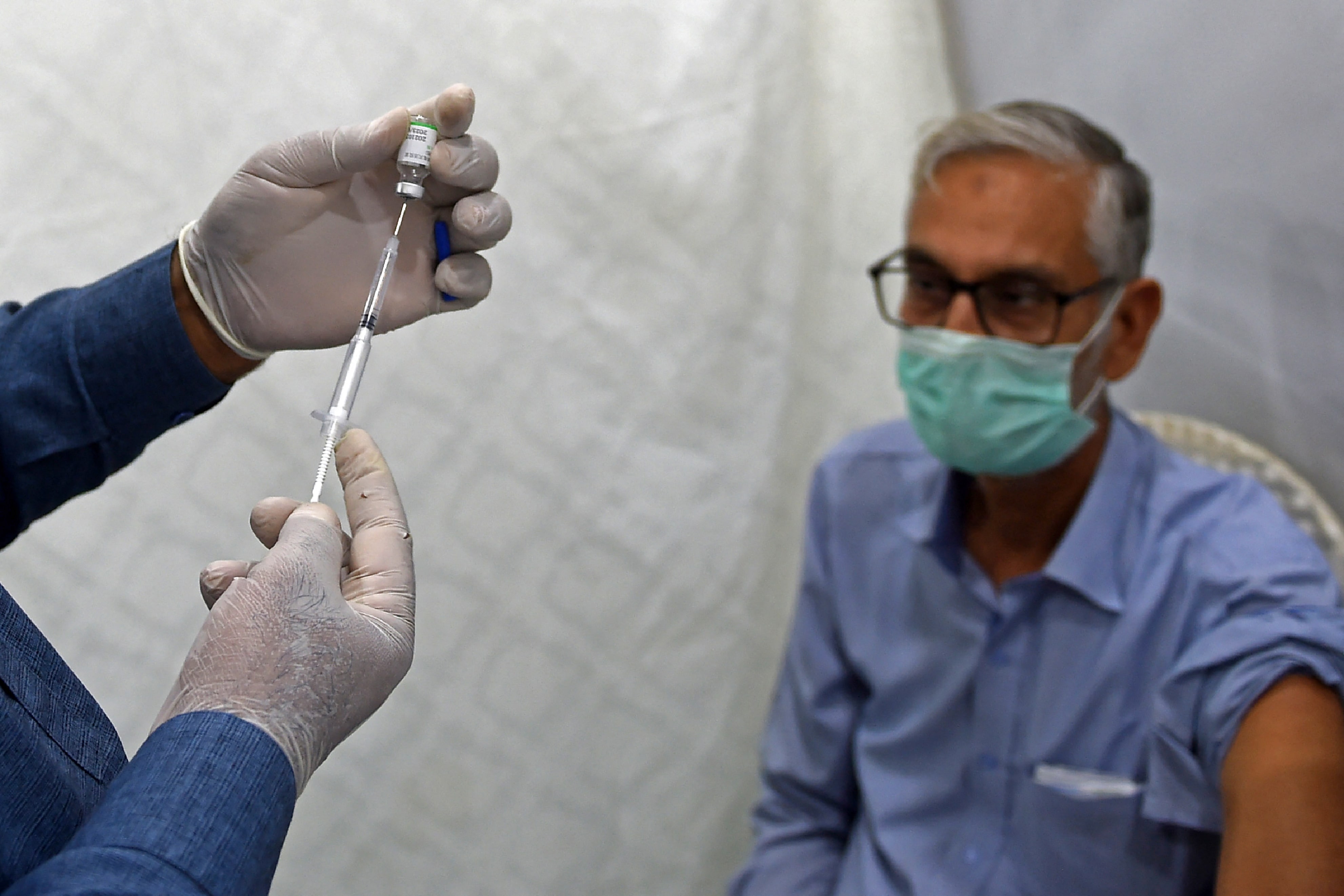 A health worker prepares to incoluate a man with a dose of Sinopharm vaccine against the Covid-19 coronavirus at a vaccination centre in Karachi on May 3, 2021. (AFP)