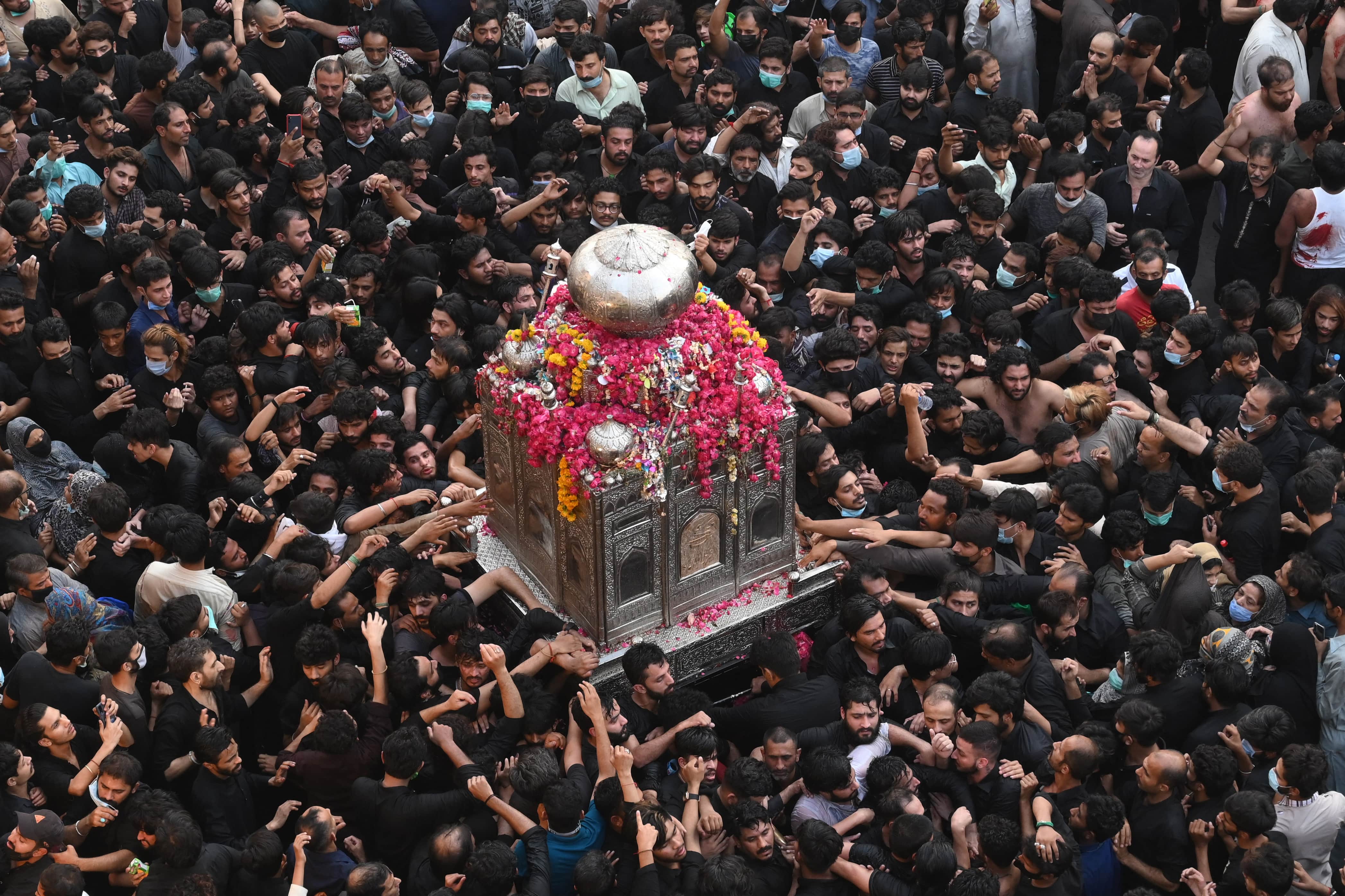 Shiite Muslim devotees take part in a procession to commemorate the death anniversary of Prophet Mohammad's companion and son-in-law Imam Ali in Lahore on May 4, 2021. (AFP)