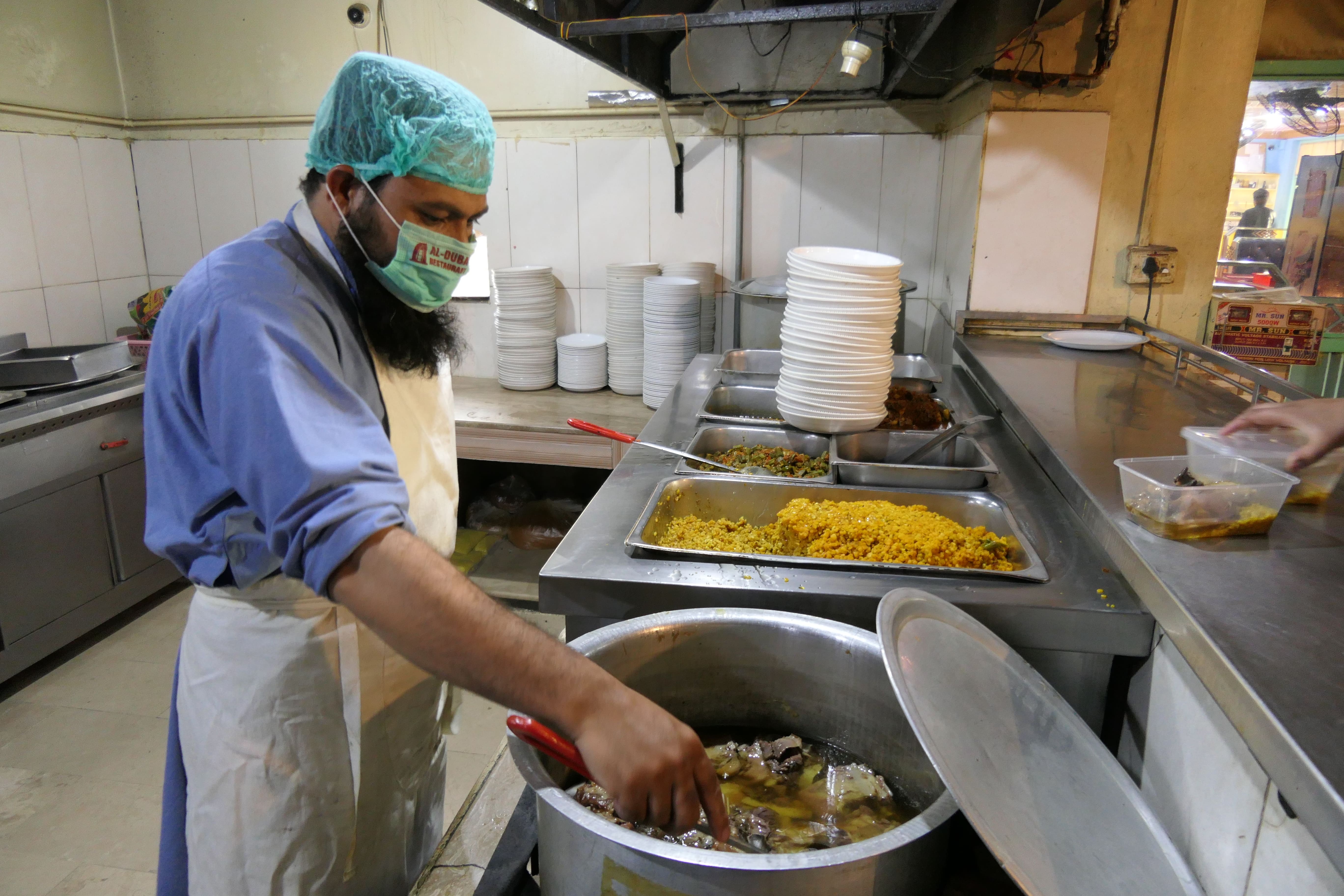 A chef at a local restaurant in Kuchlak, Pakistan, checks the softness of a ‘Rosh’ dish on May 2, 2021. (AN Photo)