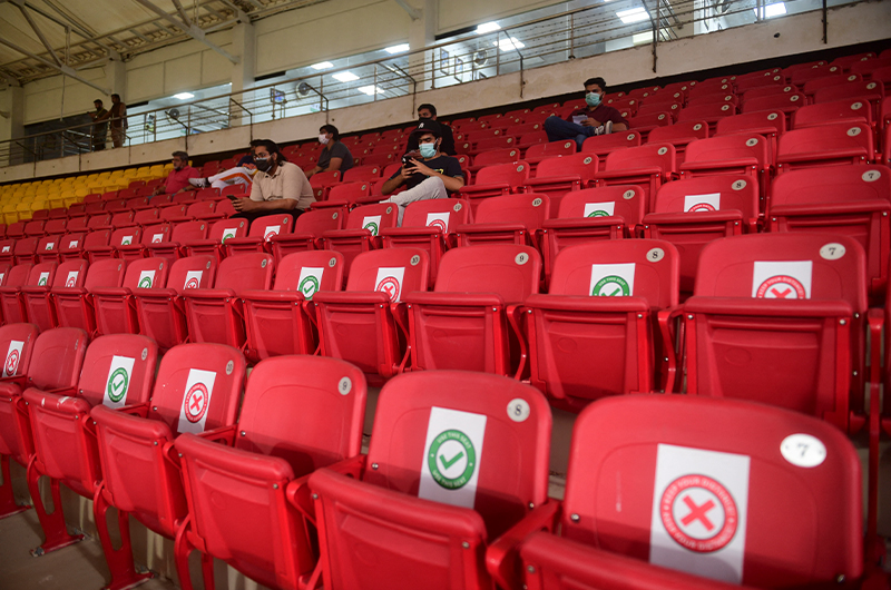 Cricket fans wearing facemasks sit on the stands before the opening ceremony of the Pakistan Super League in the National Stadium in Karachi, Pakistan, on February 20, 2021. (AFP/File