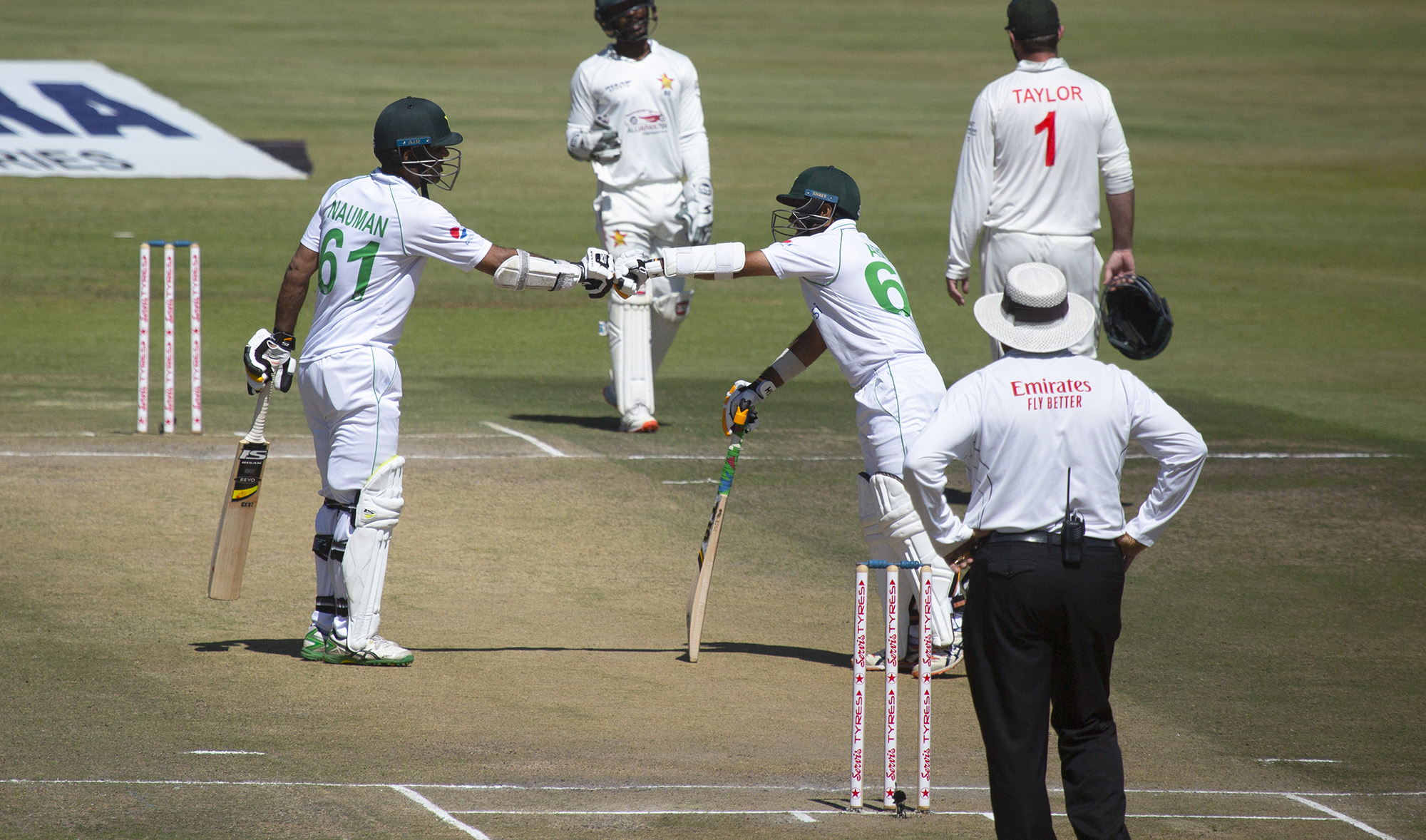 Pakistan batsman Nauman Ali, left, and Abid Ali gesture, during the second test cricket match between Zimbabwe and Pakistan at Harare Sports Club on May, 8, 2021. (AP)