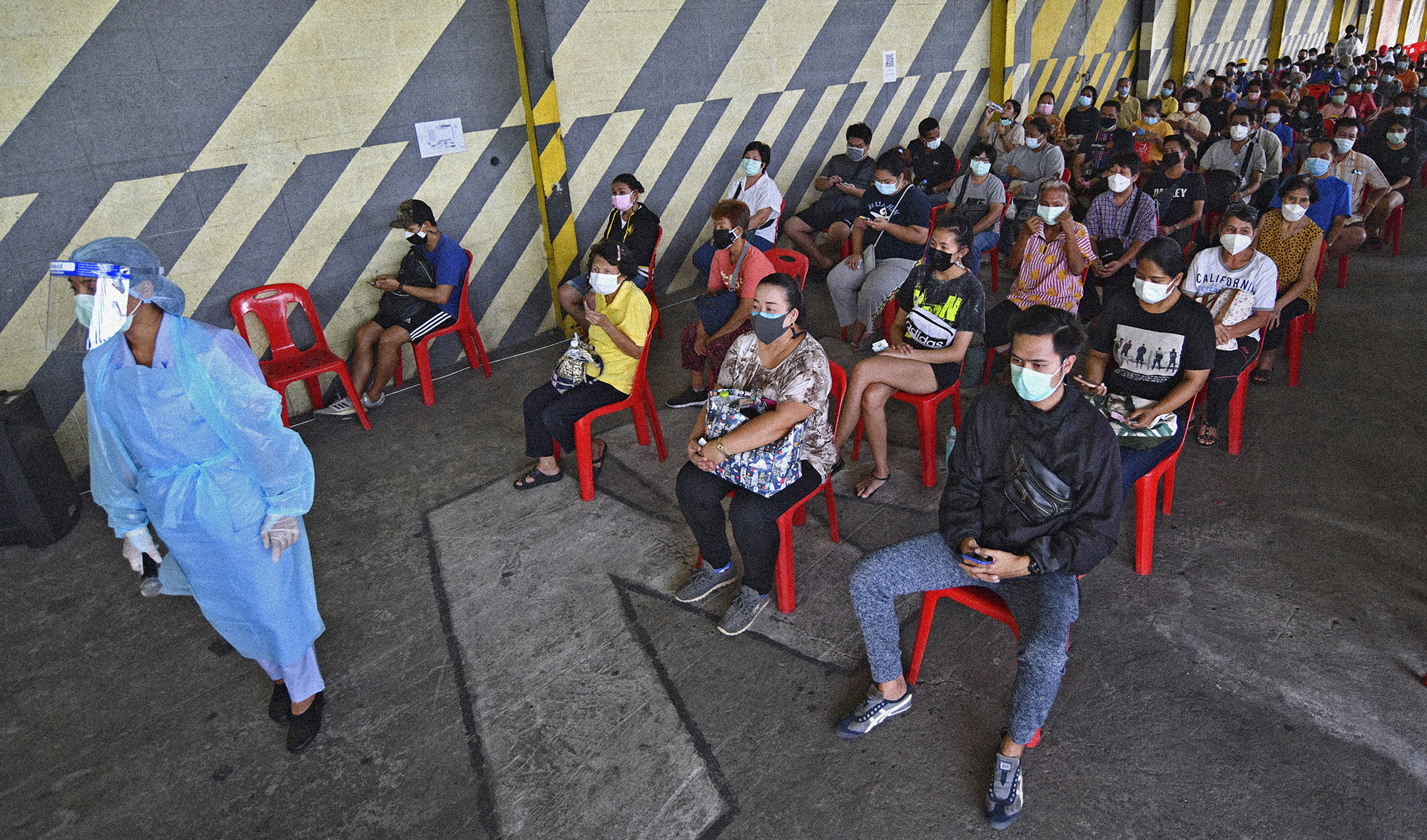 Residents of the Klong Toey area waiting to receive Sinovac COVID-19 and the AstraZeneca COVID-19 vaccines in Bangkok, Thailand, on May 10, 2021. (AP)