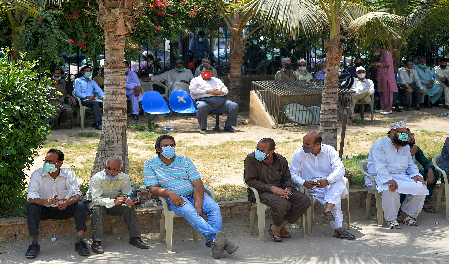 People wait get a dose of the Sinopharm Covid-19 coronavirus vaccine at a vaccination center in Karachi on May 6, 2021. (AFP)