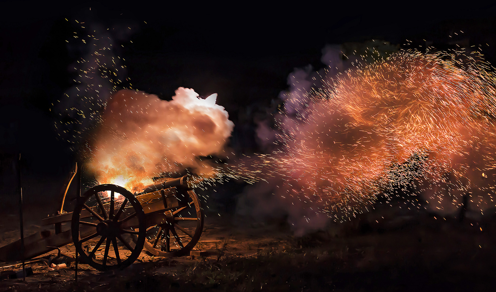 In this undated file photo, a chemical propellant ignites as a projectile is fired from a cannon at night. (Shutterstock)