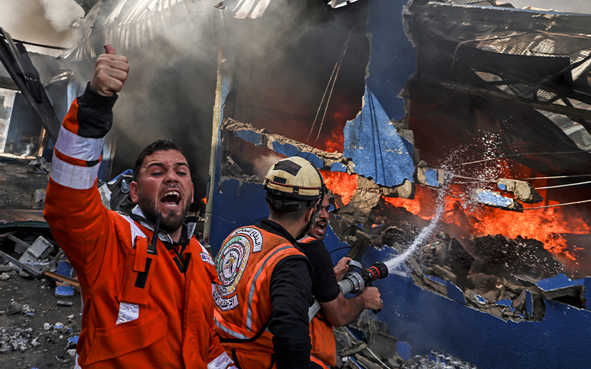 Palestinian firefighters douse a huge fire at the Foamco mattress factory following an Israeli airstrike, east of Jabalia in the northern Gaza Strip on May 17, 2021. (AFP)