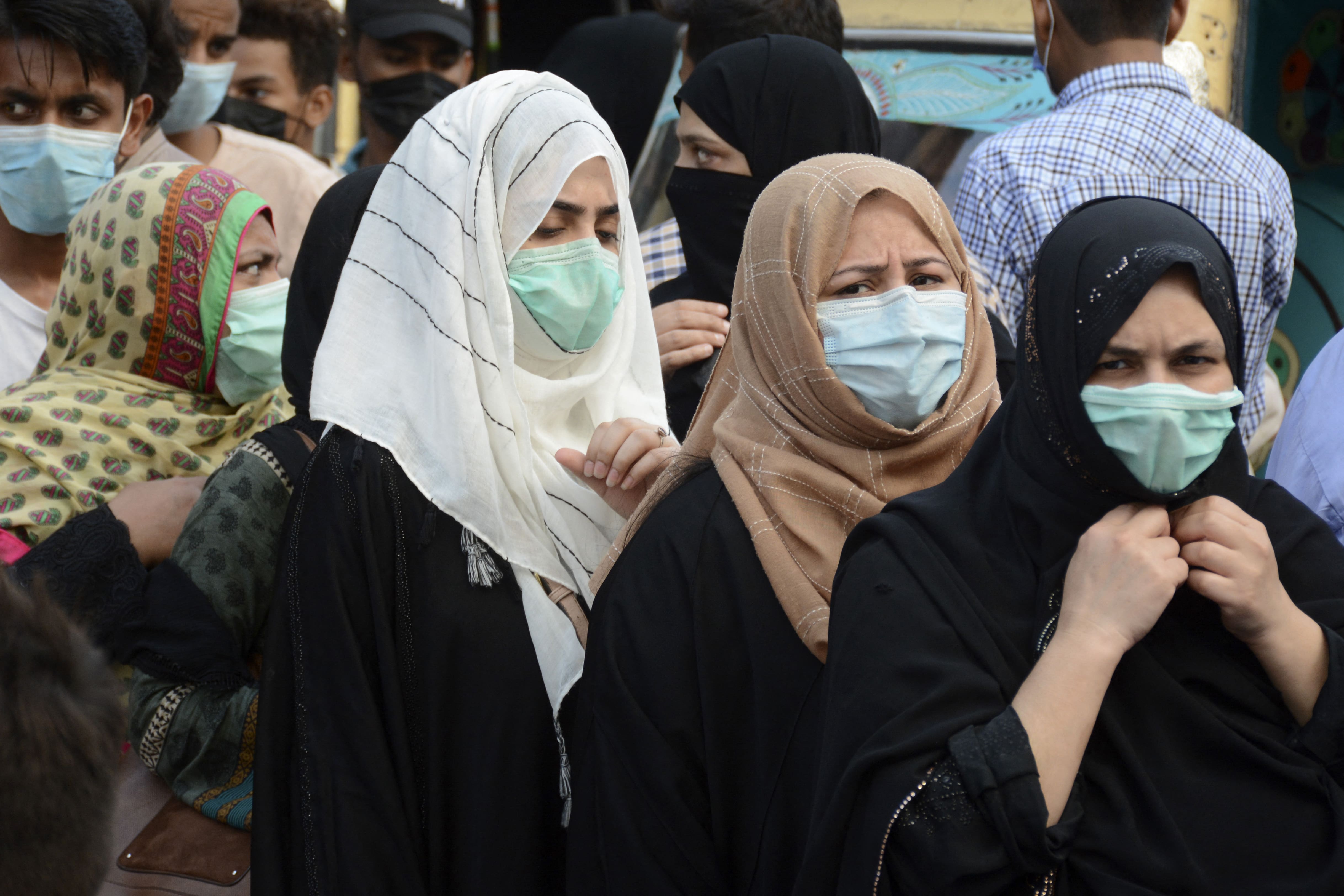 Shoppers throng a marketplace during the holy month of Ramadan ahead of the Eid al-Fitr festivities amid the Covid-19 coronavirus pandemic in Karachi on May 8, 2021. (AFP)
