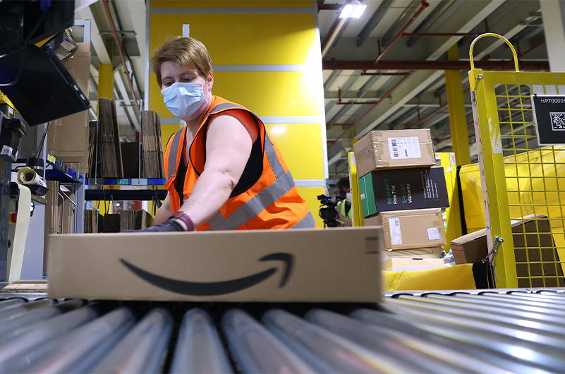 (FILES) This file photo taken on May 12, 2021 shows an employee preparing a package for shipment at the Amazon logistics centre in Suelzetal near Magdeburg, eastern Germany. (AFP)