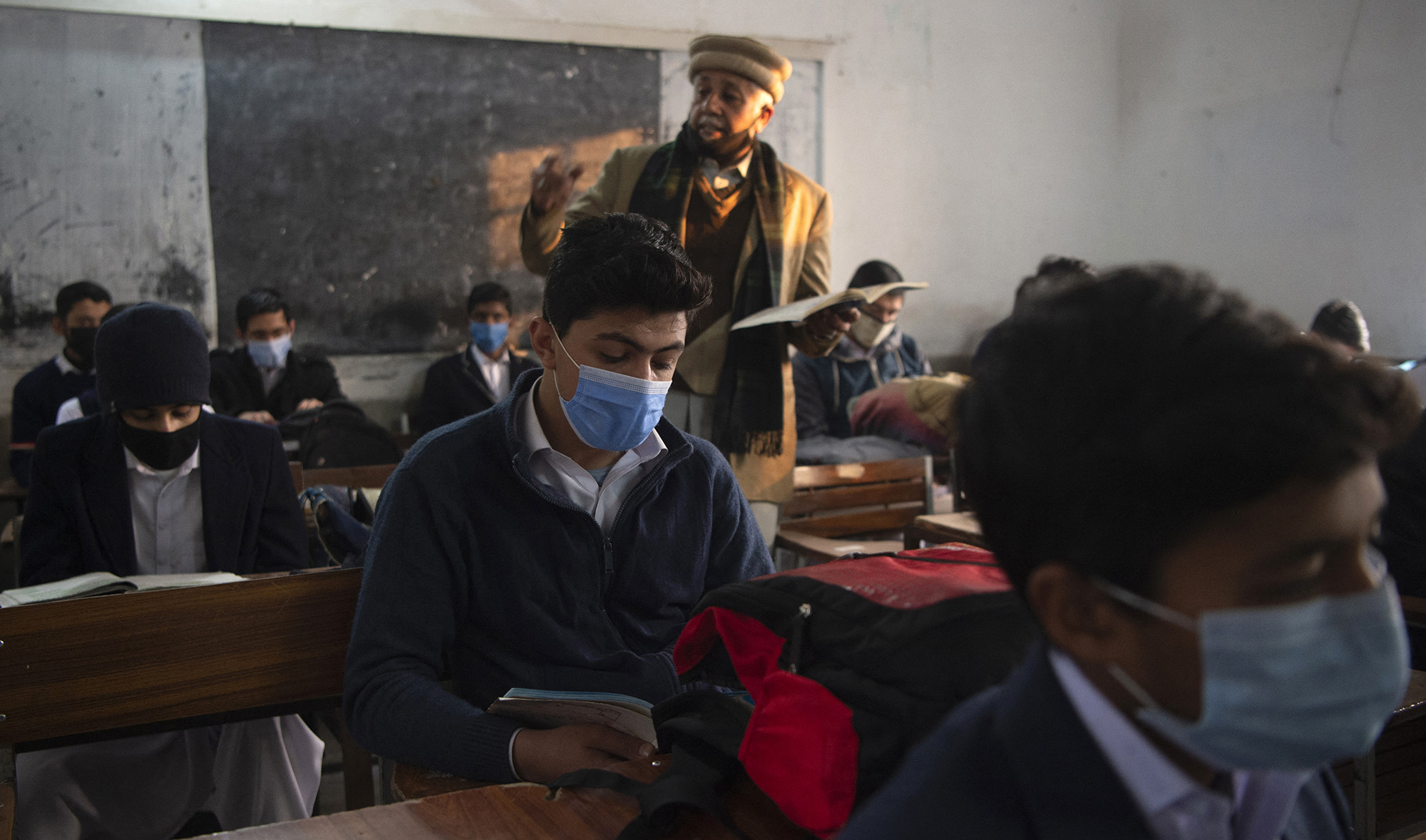 Students wearing facemasks attend a class at a school in Peshawar, Pakistan, on January 18, 2021. (AFP/File)