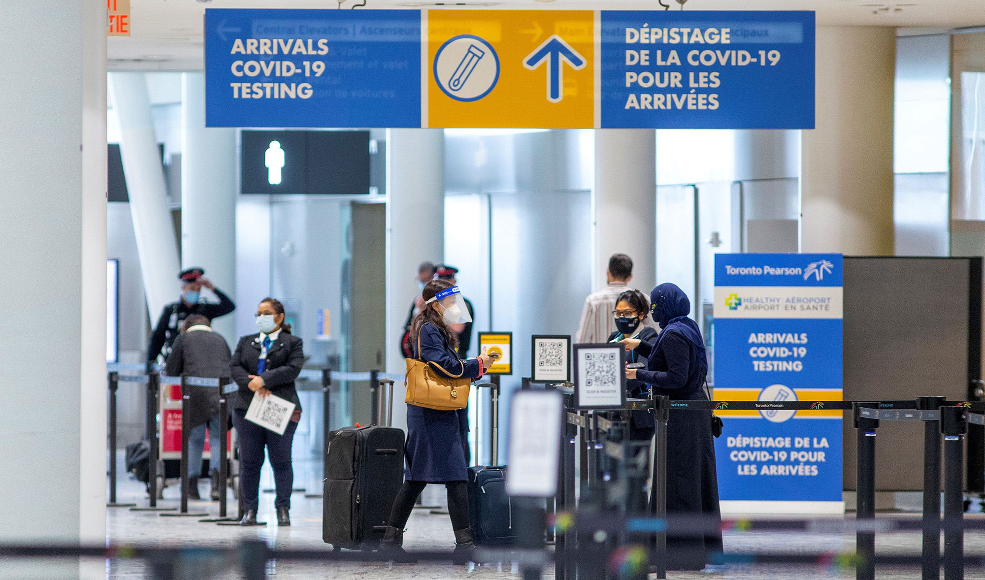 Passengers wait to be tested for COVID-19 after they arrive at Toronto's Pearson airport on February 15, 2021. (REUTERS/File)