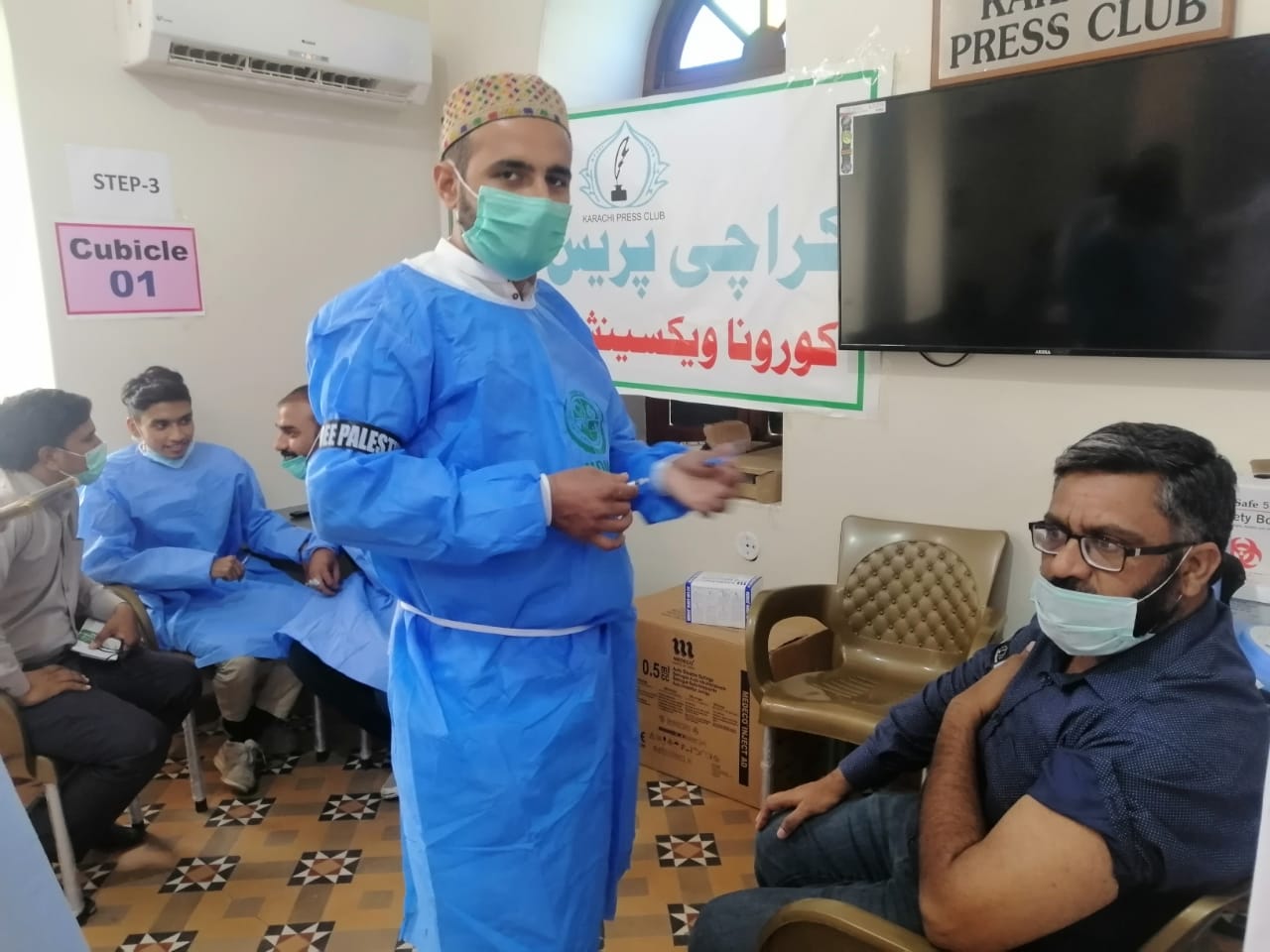 Members of the media can be seen getting inoculated with the Covishield AstraZeneca-Oxford's Covid-19 coronavirus vaccine at the Karachi Press Club in Karachi on May 25, 2021. (Photo courtesy: KPC)