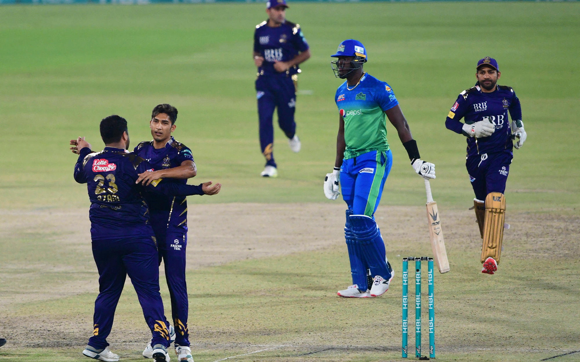 Quetta Gladiators' Mohammad Hasnain (2nd L) celebrates after taking the wicket of Multan Sultans' Carlos Brathwaite (2nd R) during the Pakistan Super League (PSL) T20 cricket match at the National Stadium in Karachi, Pakistan, on March 3, 2021. (AFP/File)
