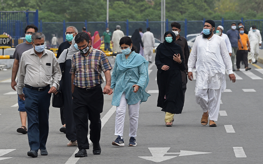 People arrive to get a dose of the Covid-19 vaccine at a vaccination center in Lahore, Pakistan, on May 23, 2021. (AFP/File)