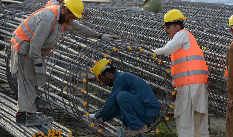 Pakistani laborer work at a construction site in Peshawar on April 30, 2018. (AFP)