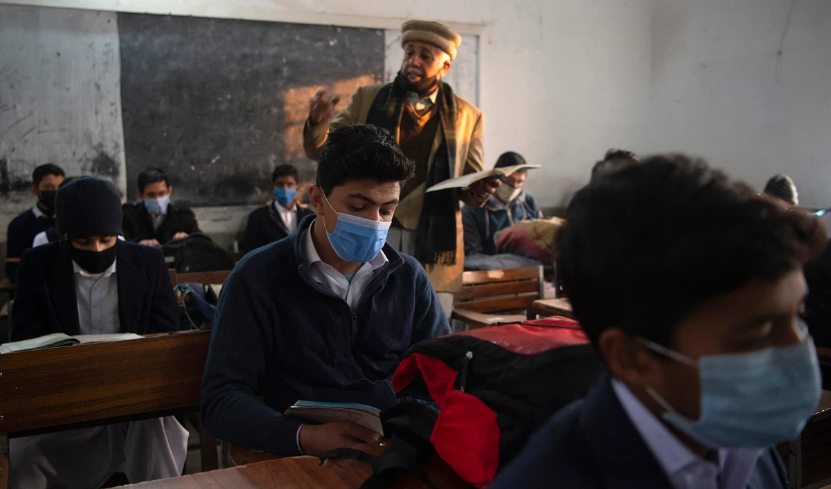 Students wearing facemasks attend a class at a school in Peshawar, Pakistan, on January 18, 2021. (AFP/File)