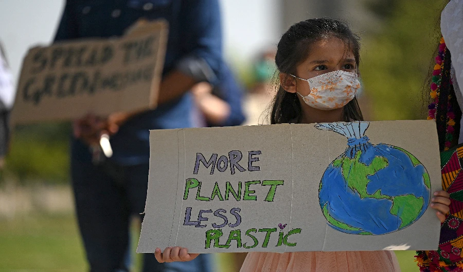 Climate activists hold placards in Islamabad on March 19, 2021. (AFP)