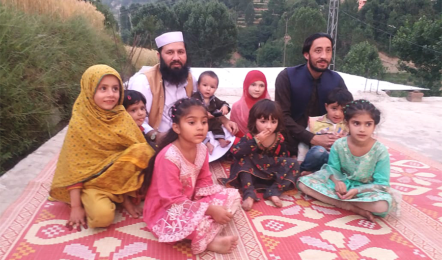 In this undated photo, Pakistani laborer Wali Muhammad (in white cap) who got 25 years in prison in a narcotics case in Saudi Arabia poses with his family in Upper Dir, Pakistan. (Photo courtesy: Wali Muhammad via AN)