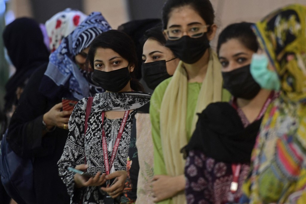 Pakistani women wait for their turn to receive a dose of the Sinovac COVID-19 vaccine at a vaccination camp in Karachi on June 3, 2021. (AFP)