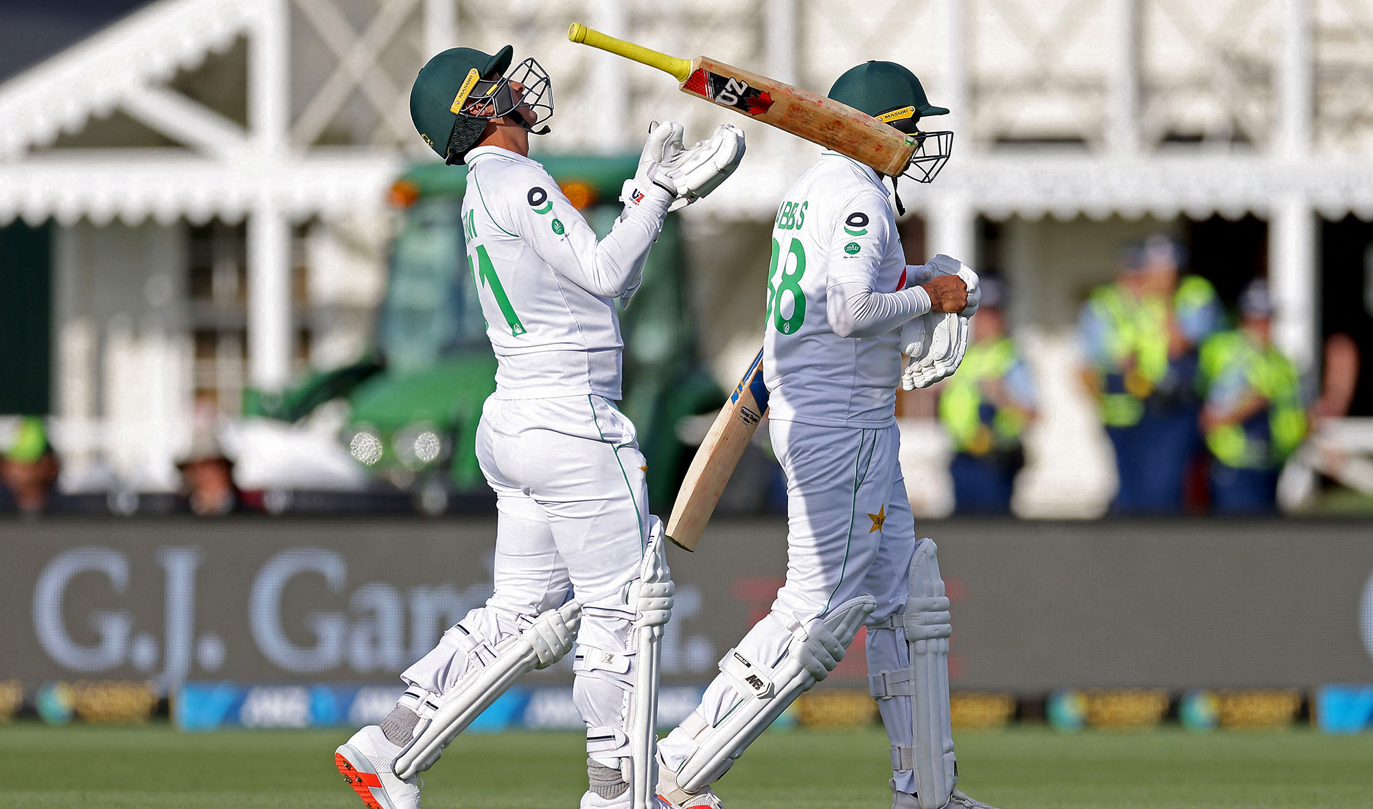 Pakistan's Naseem Shah, left, tosses his bat as he walks off with teammate Mohammad Abbas during the second cricket Test match between New Zealand and Pakistan at Hagley Oval in Christchurch on January 3, 2021. (AFP/File)