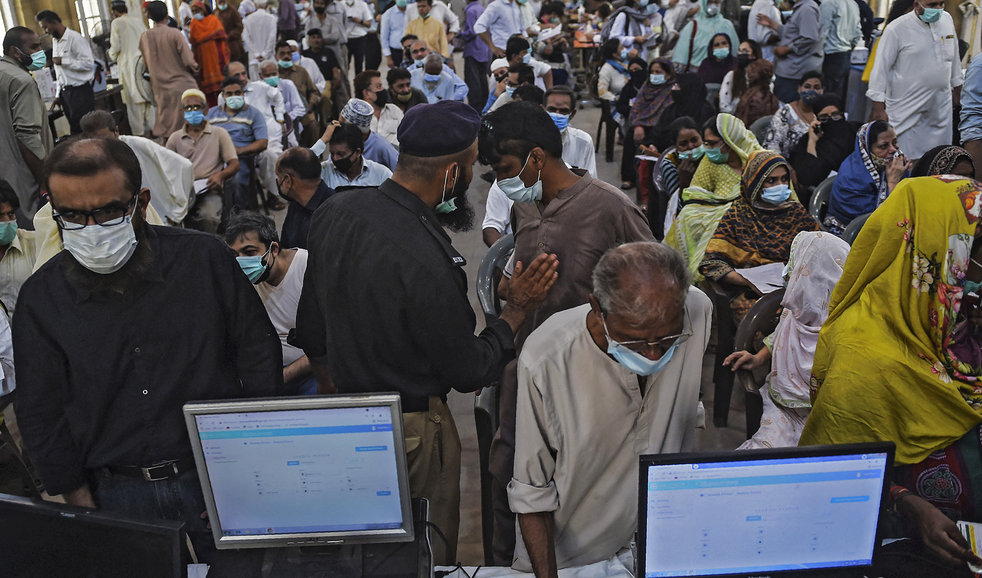 People register to receive a dose of the Covid-19 coronavirus Sinopharm vaccine at a vaccination camp in Karachi, Pakistan, on May 25, 2021. (AFP/File)