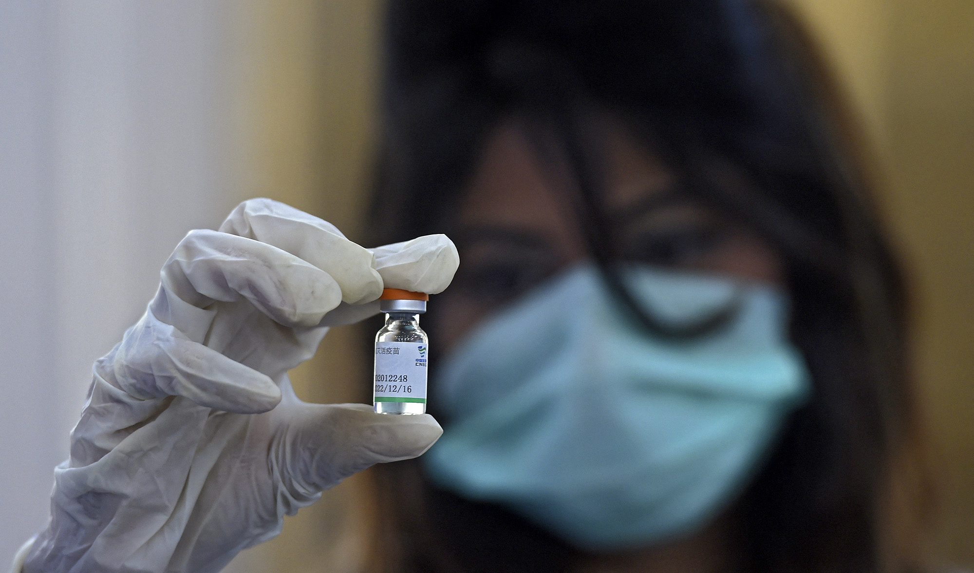 A doctor holds a vial of Chinese-made Sinopharm Covid-19 vaccine, at a vaccination centre in Karachi on February 3, 2021. (AFP/File)