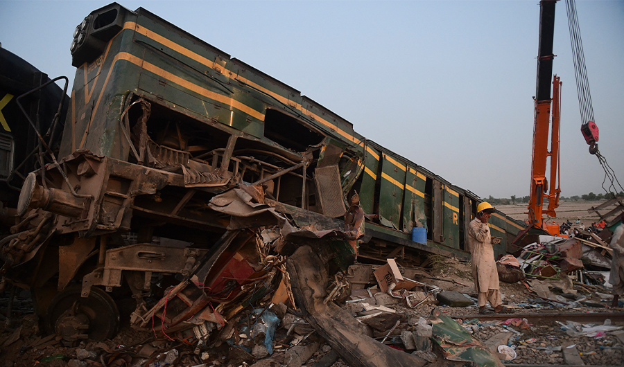 A railway worker stands at the site of a train accident in Daharki area of Pakistan's Sindh province on June 7, 2021. (AFP)