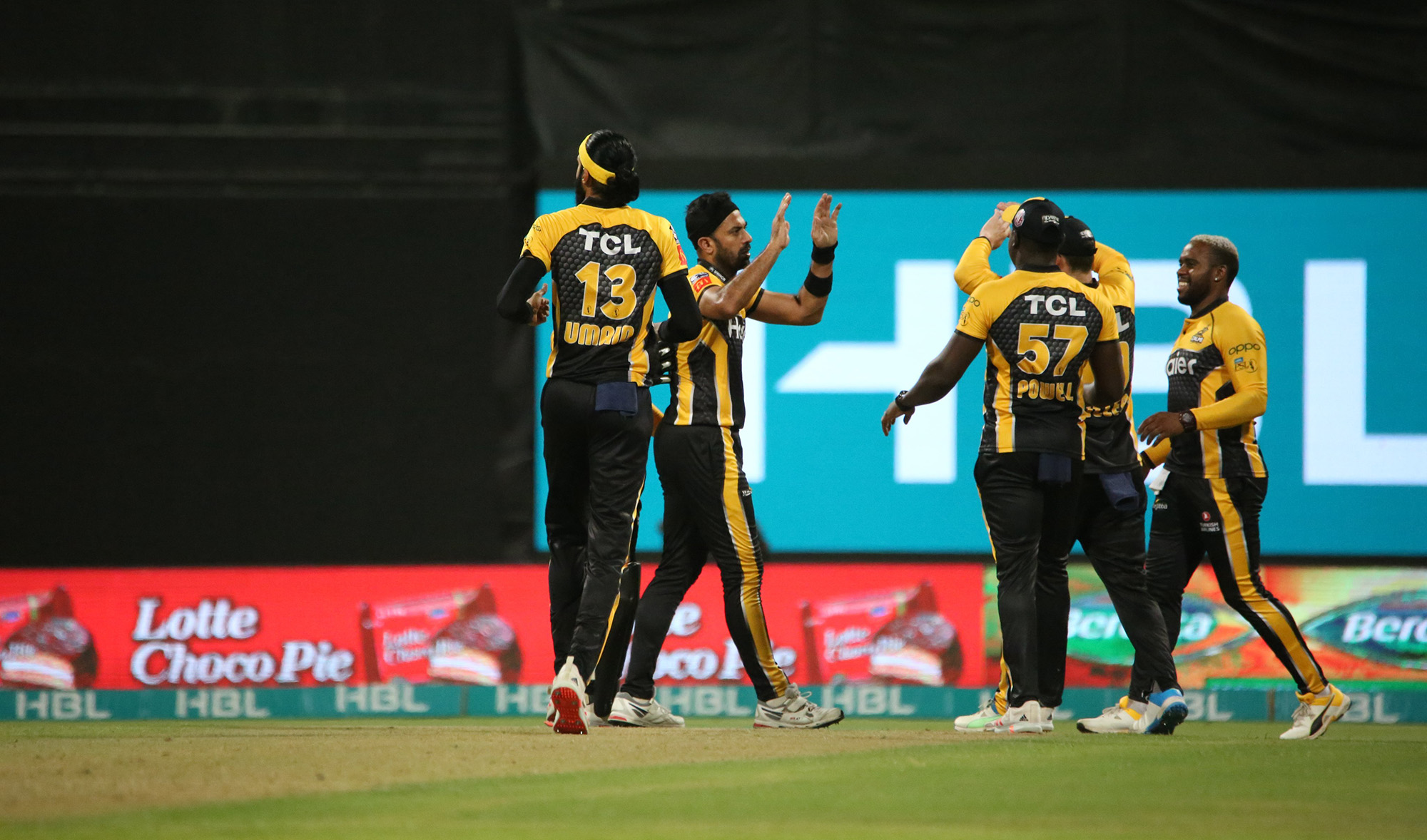 Peshawar Zalmi players celebrate after they dismissed a Lahore Qalandars batsman during a T20 cricket match in Abu Dhabi, UAE, on June 10, 2021. (Photo courtesy: @PeshawarZalmi/Twitter)