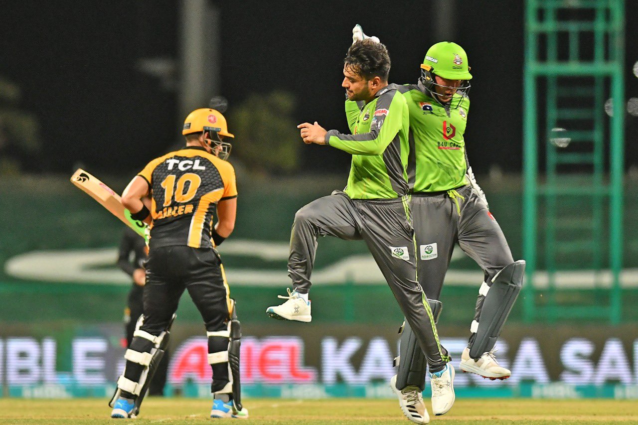 Pakistan Super League's team Lahore Qalandars player (green shirts) celebrate the dismissal of Peshawar Zalmi player (yellow shirt) in Abu Dhabi on June 10, 2021. (Photo courtesy: PSL twitter)