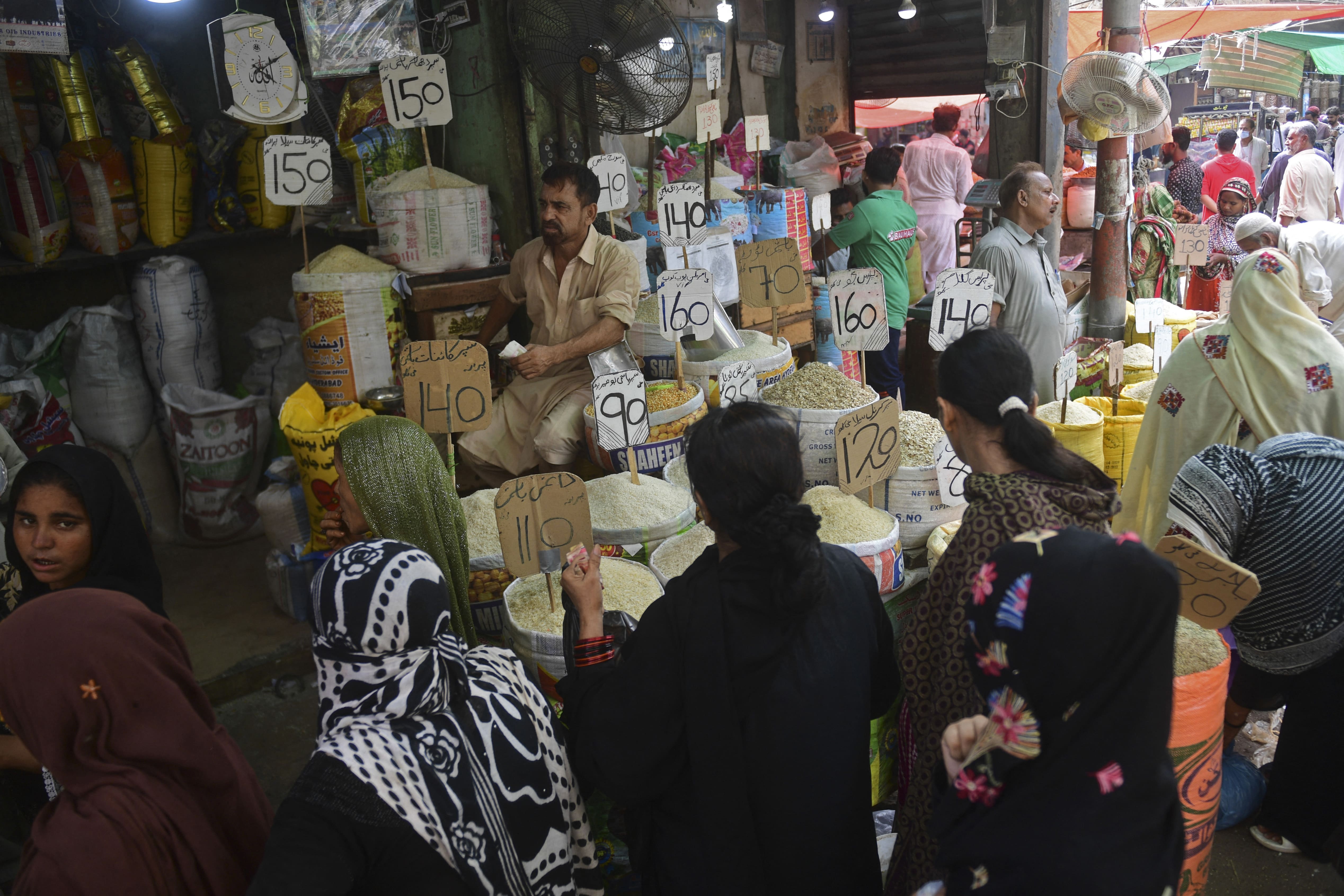 Customers crowd at a market in Karachi on June 10, 2021. (AFP)