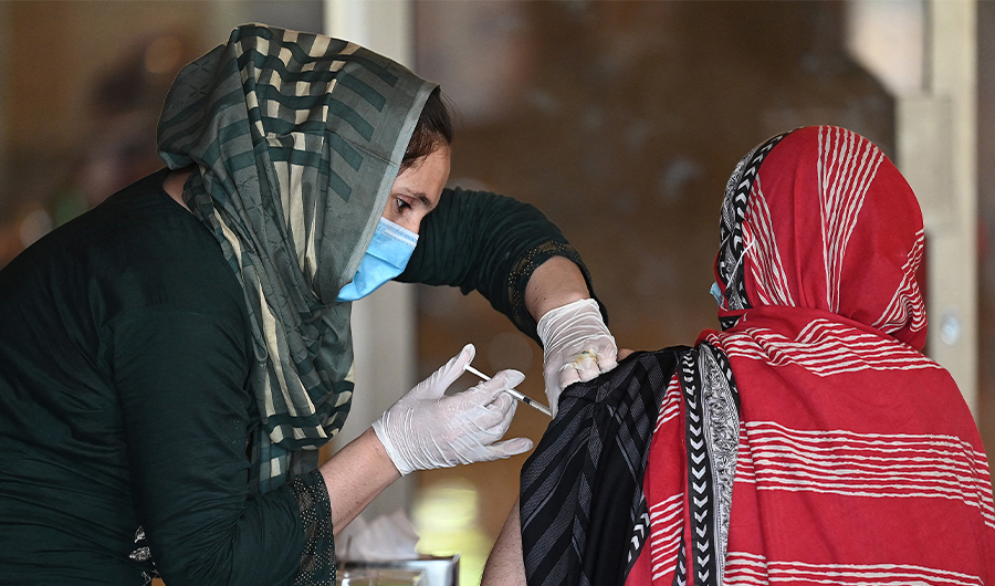 A woman receives the second dose of coronavirus Sinopharm vaccine at a vaccination camp in Islamabad, Pakistan, on May 20, 2021. (AFP)