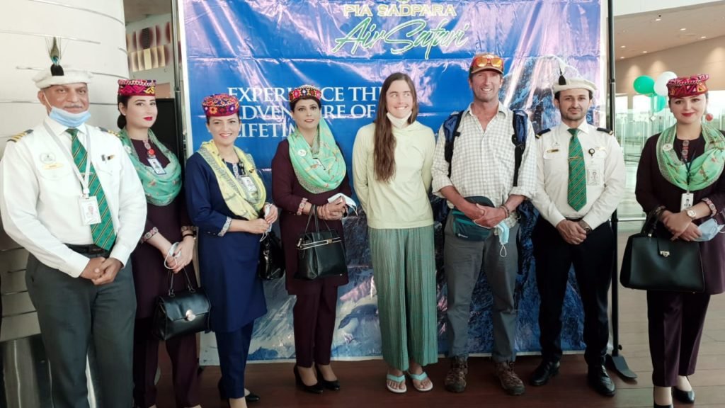 The Pakistan International Airlines crew is seen with passengers on the launch of Sadpara Air Safari on June 19, 2021. (Photo Courtesy: Social Media)
