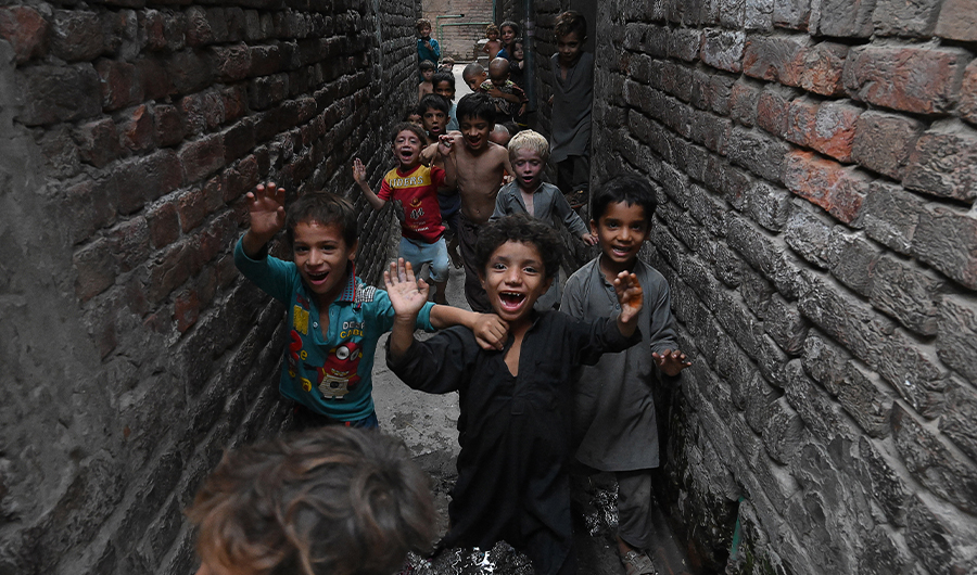 Children of Afghan refugees play at a slum area in Lahore, Pakistan, on June 19, 2020. (AFP)