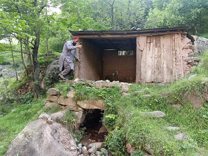 Muhammad Shafique, a resident of Chakothi village, walks by a shuttered watermill in Pakistan-administered Kashmir, April 11, 2021. (REUTERS)